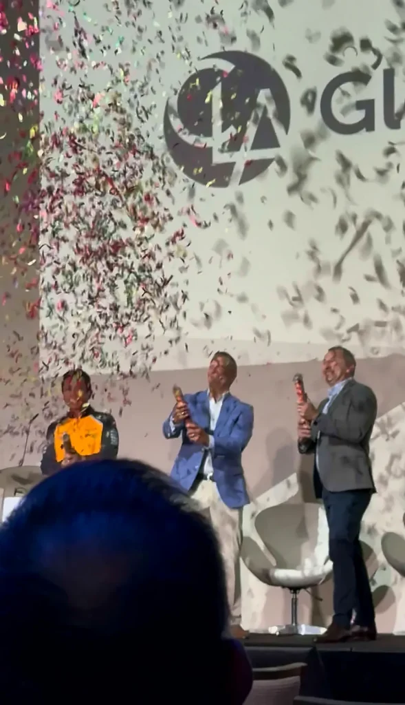 Confetti celebration on stage in front of the CLA Global logo