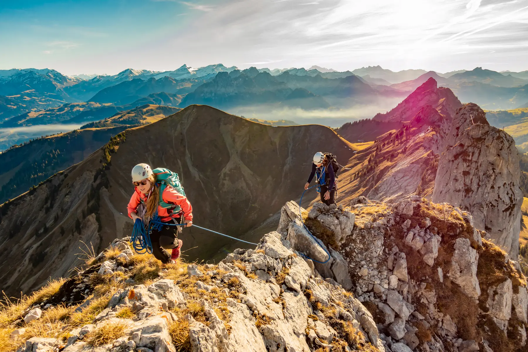 Two climbers roped together on a mountain ridge