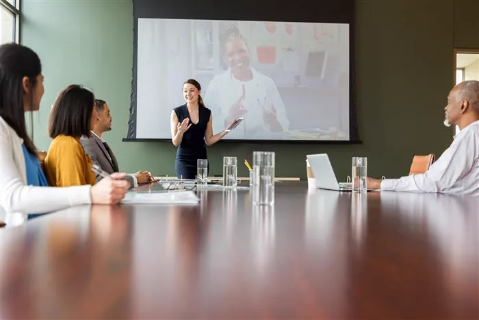 Presenter addressing a boardroom meeting
