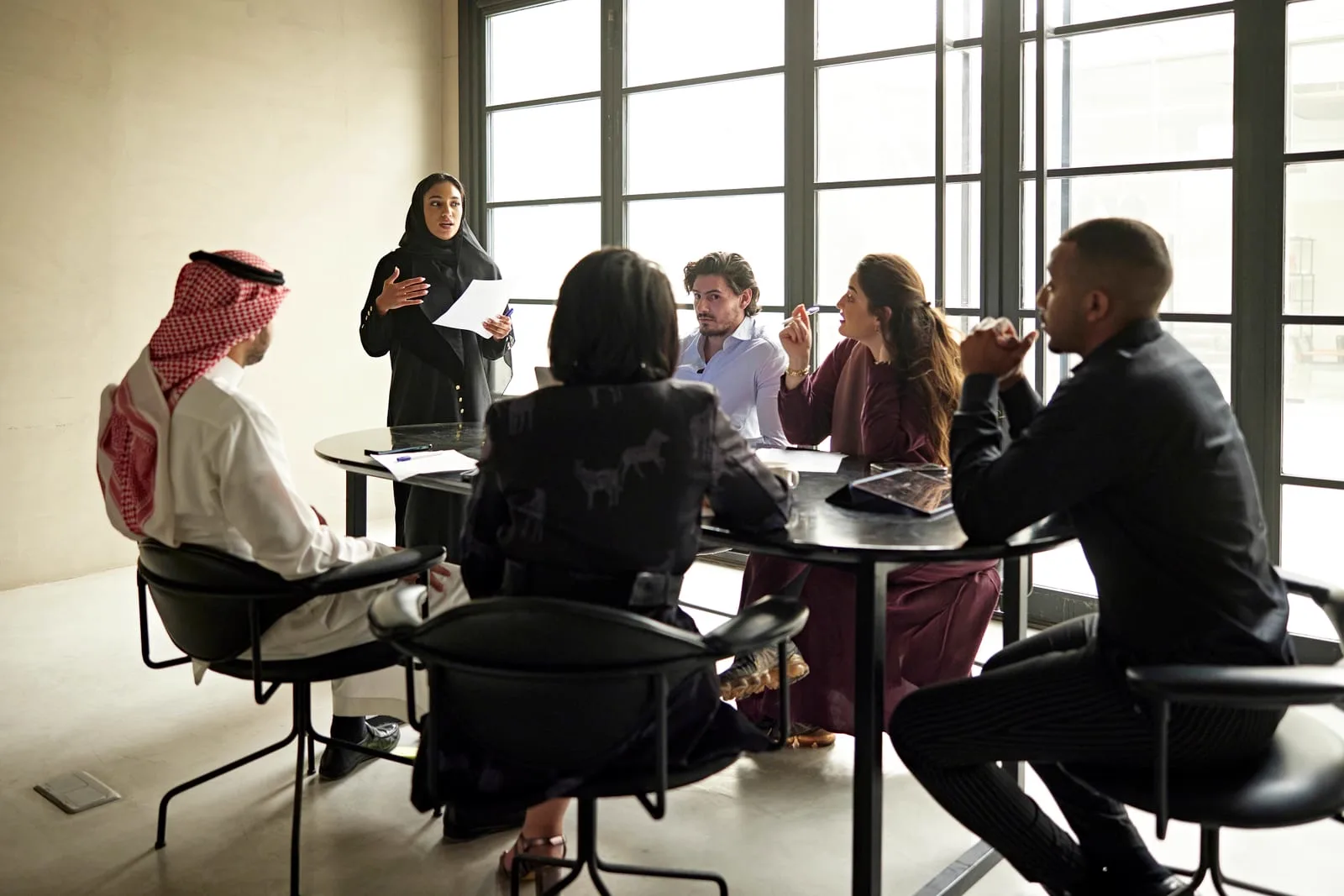 Business meeting around a table in a Qatari office