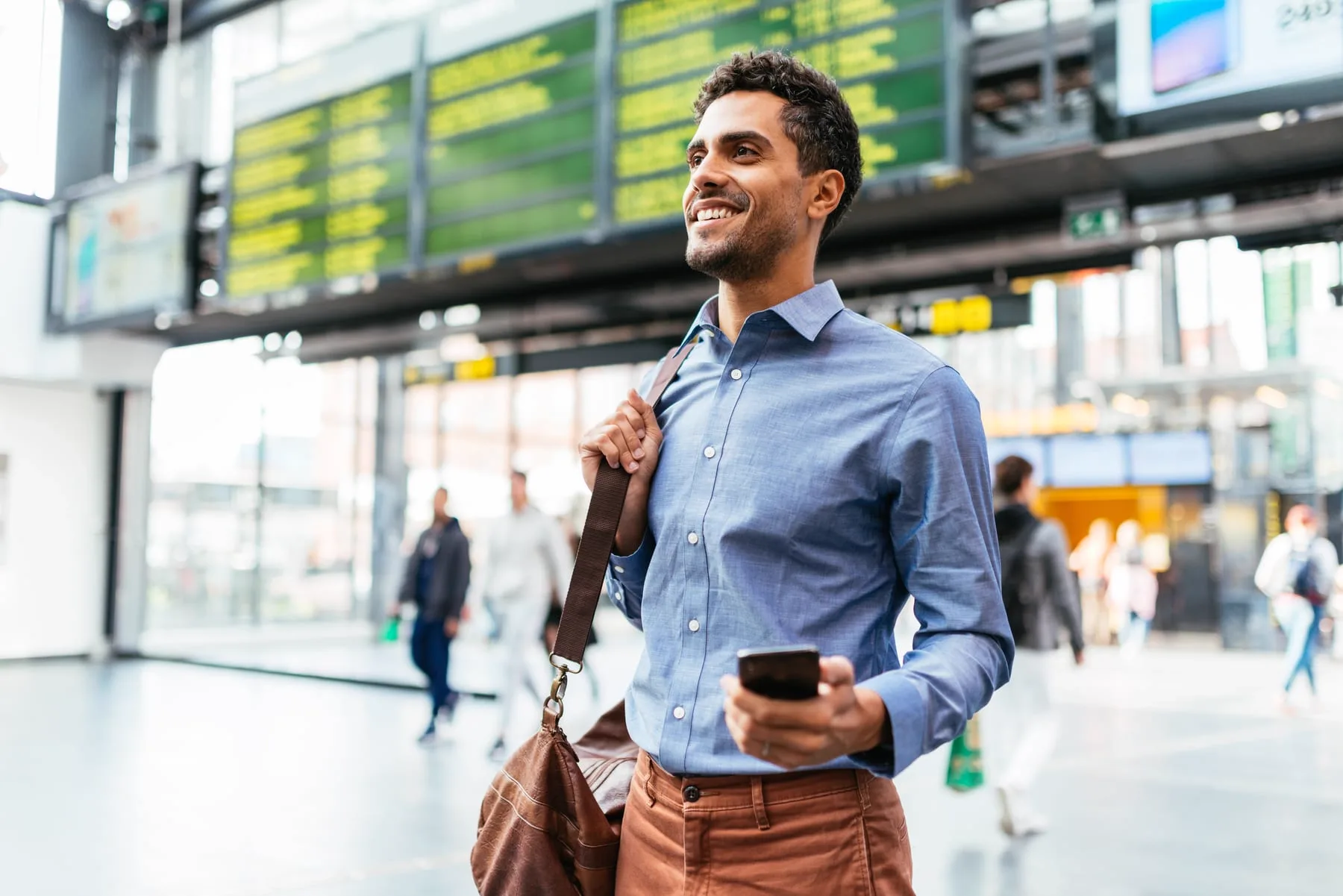 Traveller with a phone in an airport terminal