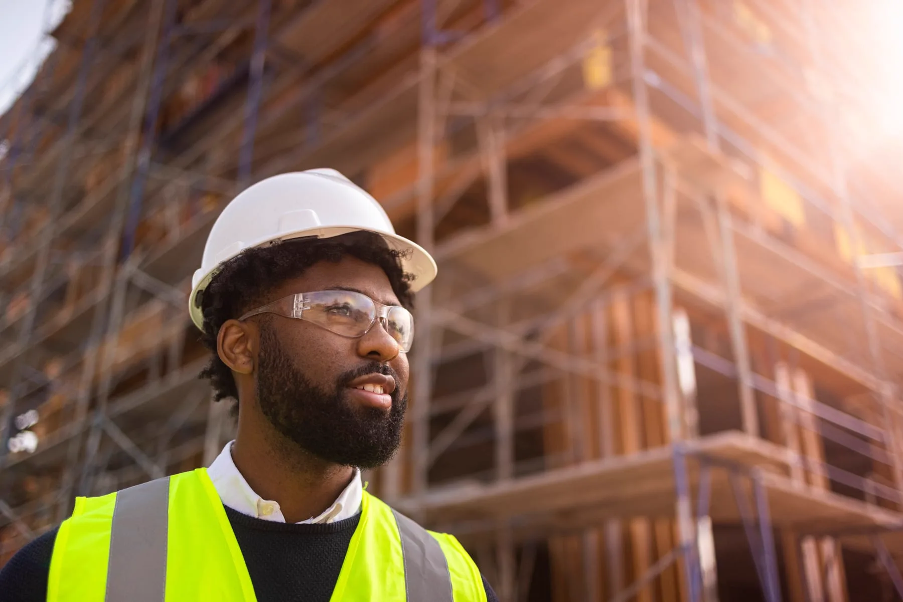 Construction worker in a hard hat beside scaffolding
